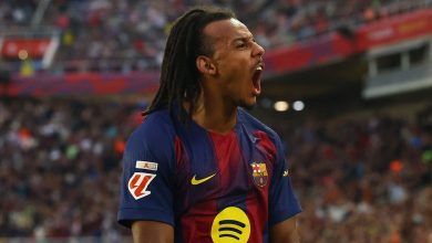 Vibrant image of a passionate football player in FC Barcelona kit celebrating on the field during a match, showcasing sports enthusiasm and team spirit.