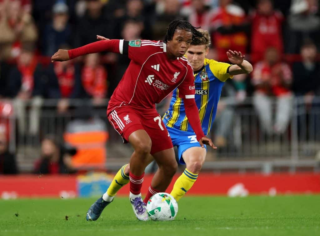 Liverpool Out to End Palace’s Unbeaten Run Aggressive soccer players competing for the ball during a match, showcasing athleticism, teamwork, and competitive spirit on the field.