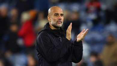 Viral football coach applauds fans during match, passionate team management, sportsmanship, soccer game action, athlete leadership, stadium crowd, sports event, passionate coaching, football strategy, game day atmosphere.