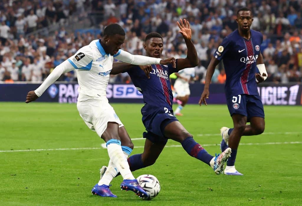 Dynamic soccer match featuring players from Olympique de Marseille and Paris Saint-Germain competing fiercely on the field.