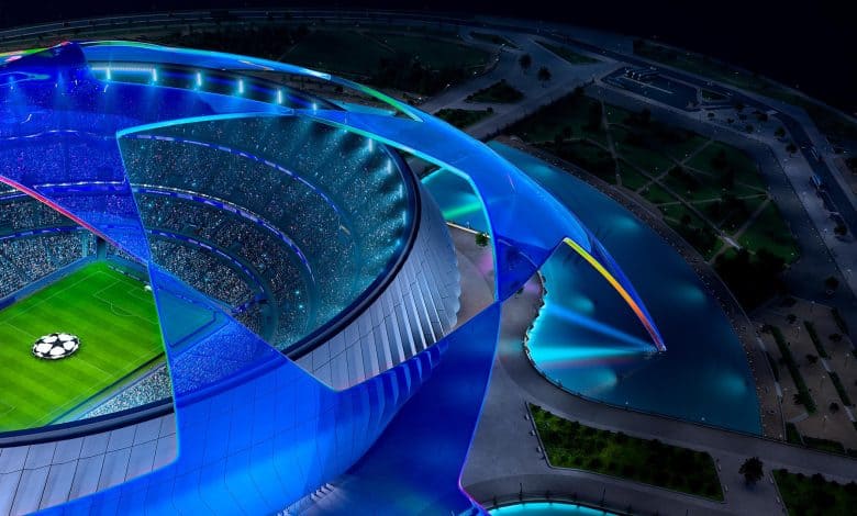Colorful futuristic stadium illuminated at night, highlighting modern architecture and vibrant lighting.