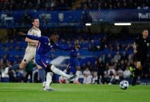 Rain-soaked soccer match featuring players from Chelsea FC and opposing team, intense action during a UEFA Champions League game at ZareSport.et.