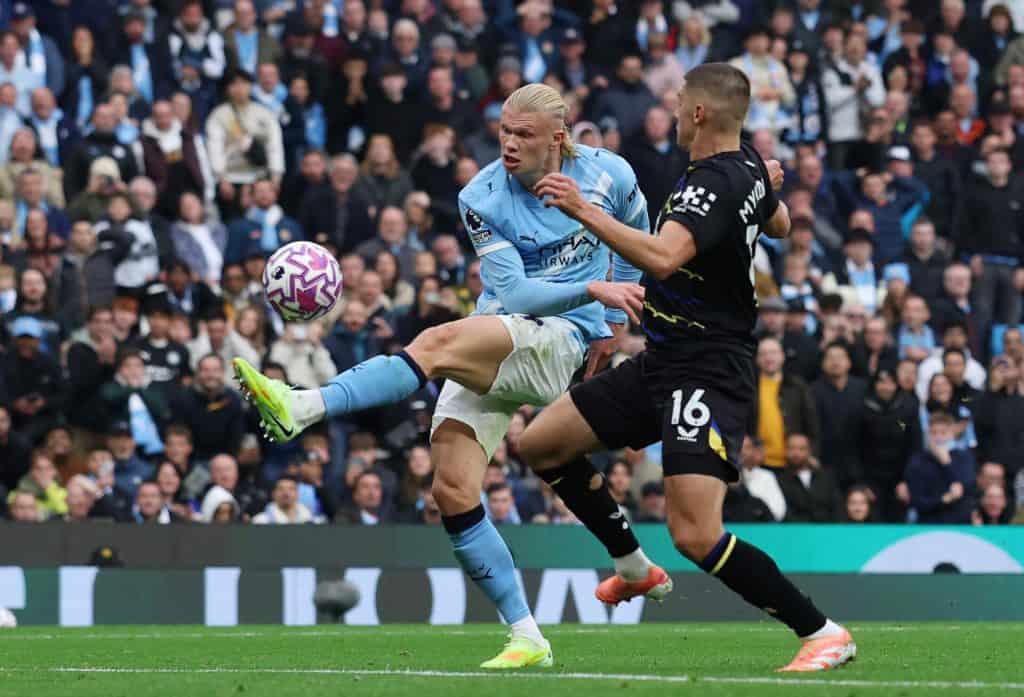Exciting soccer match between Manchester City and a rival team with players competing fiercely on the field.
