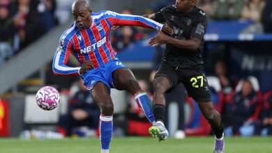 Dynamic soccer match action with two players competing for ball possession on the field.