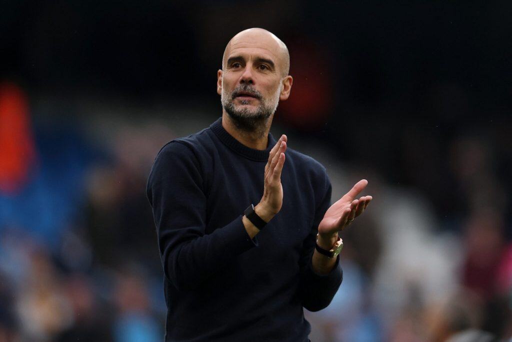 Super Sunday: Drama Awaits in the Premier League Dynamic sports coach clapping during a match emphasizing motivation and leadership at a sports event.