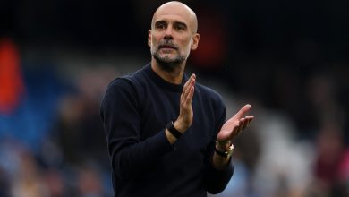 Dynamic sports coach clapping during a match emphasizing motivation and leadership at a sports event.