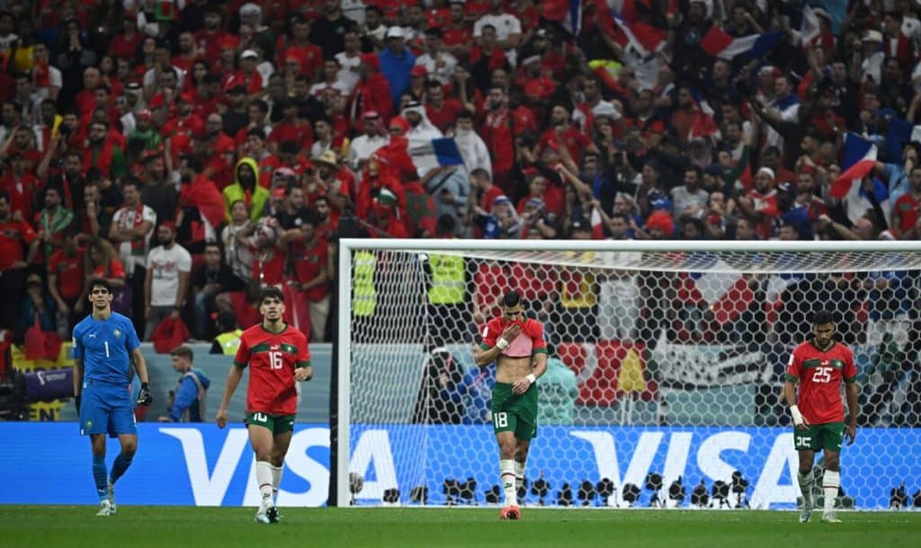 Goals, Chaos, and Comebacks: Africa’s Final Qualifying Night! Vibrant soccer match between Iran and an opposing team, stadium filled with passionate fans waving flags, players displaying intense emotions during the game.