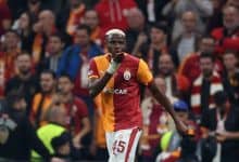 Vibrant soccer player celebrating with fans in the stadium, wearing team jersey with the number 45, during an intense match, showcasing passion and team spirit.