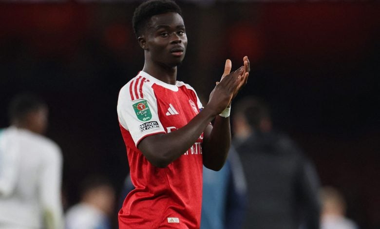 Fast football player celebrating on the field in a red and white jersey, team logo visible, during a match, sports action, athlete in motion, team sports, ZareSport.et focus.