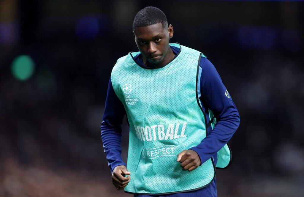 Young football player in UEFA Champions League training gear during match warm-up.
