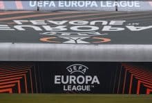 UEFA Europa League logo on a stadium advertising board during a football match, showcasing the official branding and modern graphic design elements.
