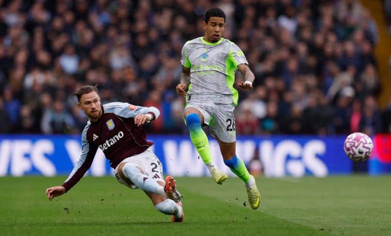 Dynamic soccer players competing during match, one sliding while the other jumps for the ball, on a professional football field, emphasizing sports competition, athleticism, and teamwork.