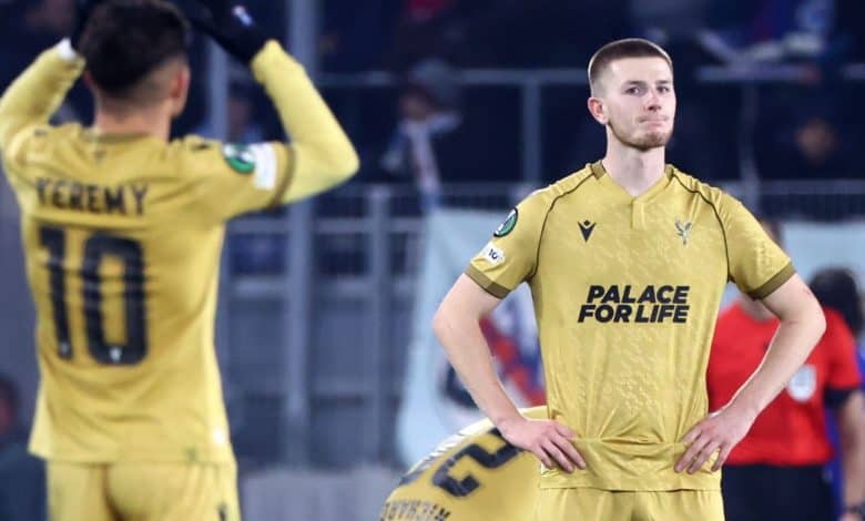 Soccer players wearing yellow uniforms on the field, one looking serious with hands on hips and the other adjusting their jersey, emphasizing sportsmanship and team spirit.