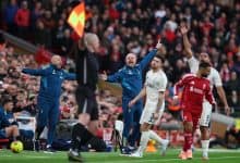 Vibrant soccer match scene with passionate players and coaches on the sideline during a competitive game, capturing intense moments and team emotions in a stadium filled with cheering spectators.