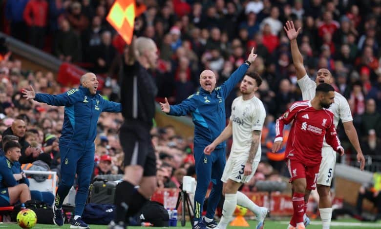 Vibrant soccer match scene with passionate players and coaches on the sideline during a competitive game, capturing intense moments and team emotions in a stadium filled with cheering spectators.