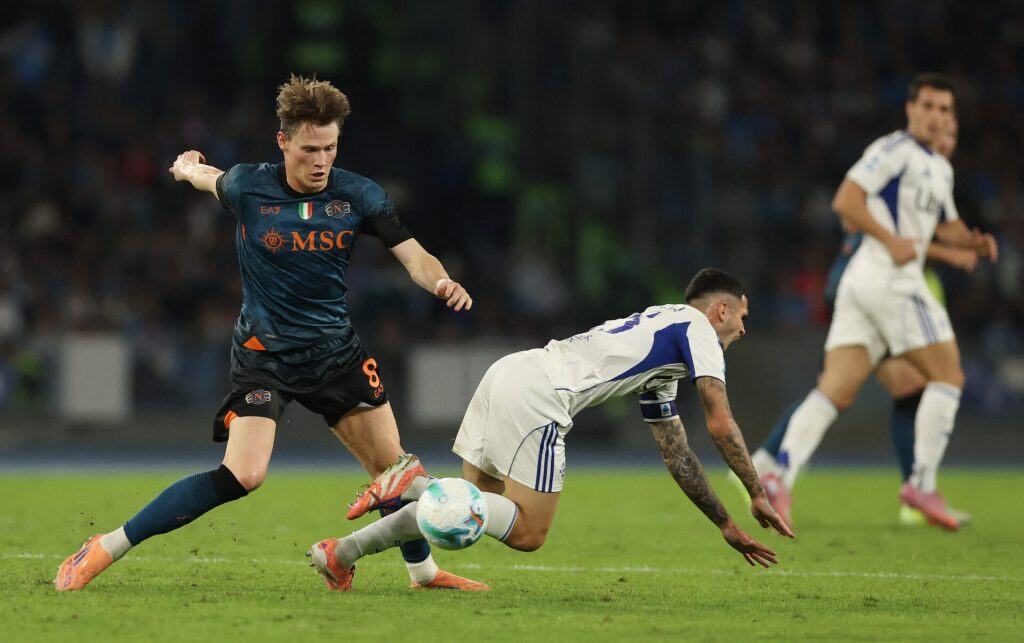 Dynamic soccer players competing for the ball during a match, showcasing competitive sports action and athletic skill.