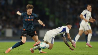 Dynamic soccer players competing for the ball during a match, showcasing competitive sports action and athletic skill.