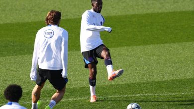 Professional soccer players practicing on the field during training session.