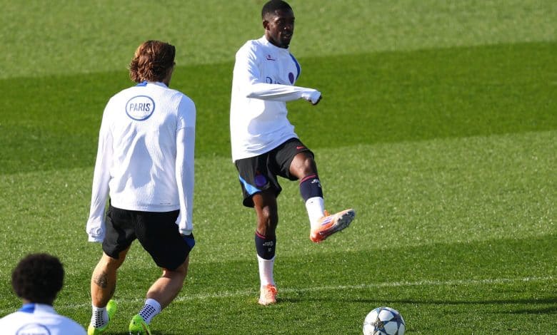 Professional soccer players practicing on the field during training session.