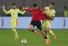 Intense soccer match with players competing fiercely for the ball on the field, showcasing teamwork and athleticism during a professional game.