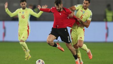 Intense soccer match with players competing fiercely for the ball on the field, showcasing teamwork and athleticism during a professional game.