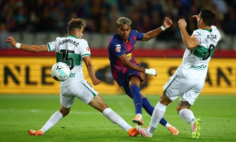 Dynamic soccer match between players wearing colorful jerseys, showcasing intense action on the field during a competitive game.