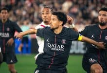 Celebrating football victory featuring PSG players in action; team sport, soccer celebration, professional football match, sports team, team unity, athletic competition, stadium atmosphere, player camaraderie, match winning moment.