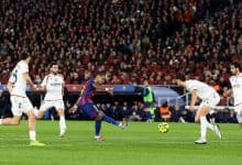 High-energy soccer game between FC Barcelona and opponents in white kits during a competitive match.