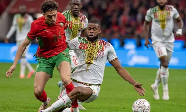 Football players competing on the field, showcasing athleticism and teamwork during a live soccer game.