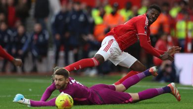 Dynamic soccer match with players competing intensely for the ball on the field.