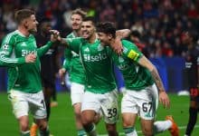 Soccer players celebrating after scoring a goal in a high-intensity match.