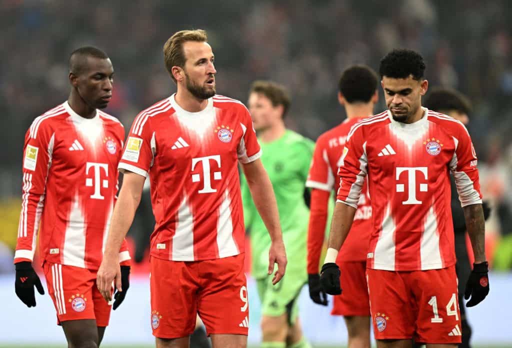 A group of professional footballers in red and white jerseys representing Bayern Munich during a game.