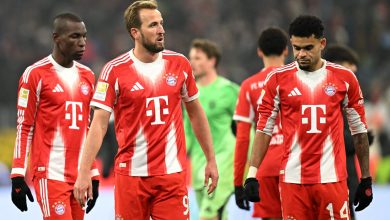 A group of professional footballers in red and white jerseys representing Bayern Munich during a game.