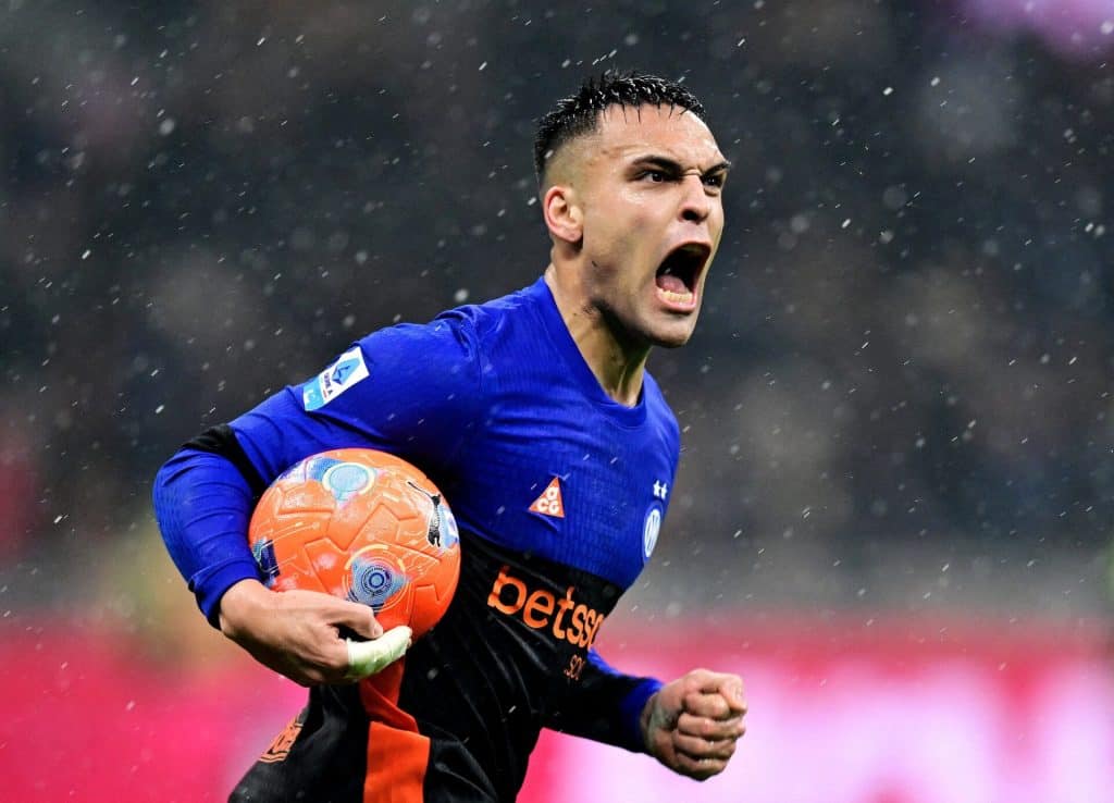 An energetic soccer player passionately celebrating on the field during a rainstorm, clutching the ball, showcasing intense emotion, athleticism, and determination in a competitive match.