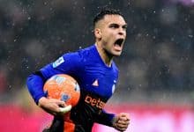 An energetic soccer player passionately celebrating on the field during a rainstorm, clutching the ball, showcasing intense emotion, athleticism, and determination in a competitive match.