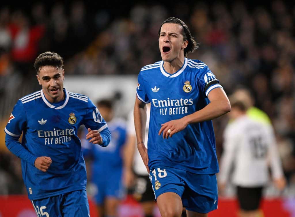 Real Madrid players celebrating after scoring a goal during a football match.