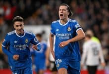 Real Madrid players celebrating after scoring a goal during a football match.