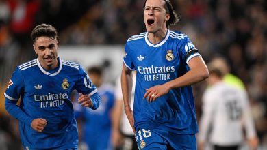 Real Madrid players celebrating after scoring a goal during a football match.