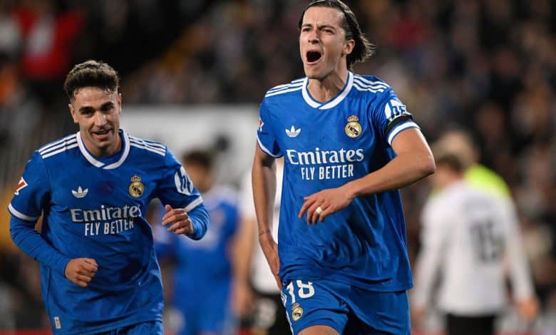 Real Madrid players celebrating after scoring a goal during a football match.